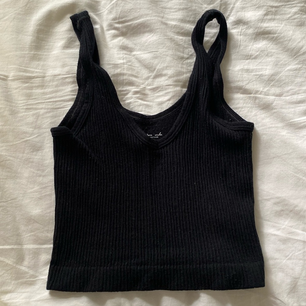 Out from under black crop tank top